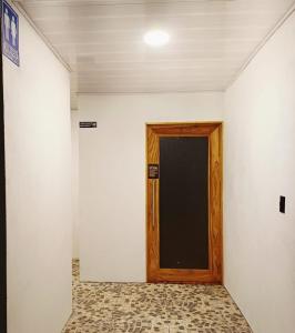 a wooden door in a room with a wall at Camping Green house in Palma +19 photos