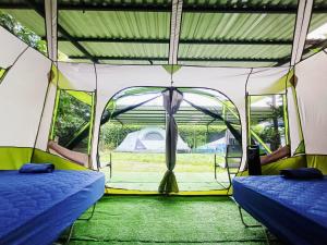 two beds in a tent with a tent at Camping Green house in Palma