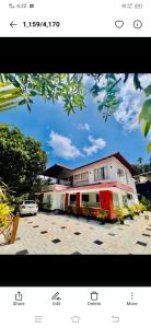 a picture of a building with a car parked in front at Royal Heaven Wayanad in Ambalavayal