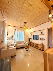 a living room with a couch and a table at JND Cozy Homes in Iringa