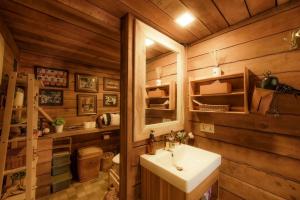 a bathroom with a white sink and wooden walls at Morning Star Glamping in Ban Pok Nai +69 photos