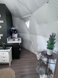 a attic room with a sink and a table at Cabaña in Pirque