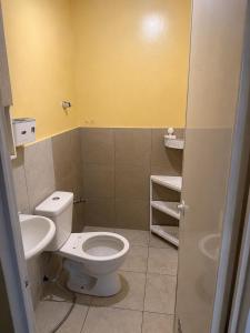 a bathroom with a toilet and a sink at Sanest Transient House in Subic