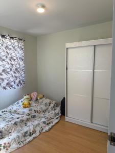 a bedroom with a bed and a large closet at Sanest Transient House in Subic