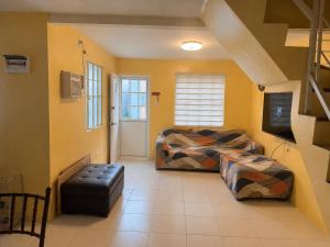 a room with two beds and a tv in it at Sanest Transient House in Subic