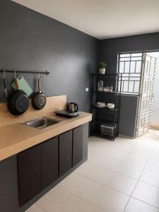 a kitchen with a sink and a counter top at Sanest Transient House in Subic