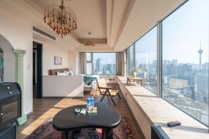 a living room with a view of a city at INVIS Urban High-rise Suites in Chengdu