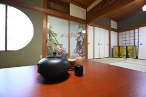 a vase sitting on a table in a room at 縁-en- in Zentsuji