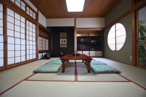 a room with a table in a room with windows at 縁-en- in Zentsuji