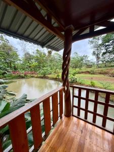 a view of a river from a wooden balcony at House Rio Celeste Paradise in Rio Celeste