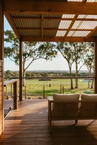 a porch with couches and a view of a field at Monapilla Escape in McLaren Vale