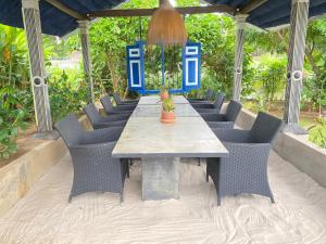 a table with chairs and a potted plant on it at Waterland in Negombo