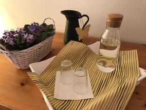 a bottle of wine and two glasses on a table at Villa Tourmaline in Kremnica