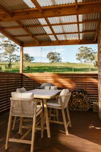 a wooden table and chairs on a patio at Monapilla Escape in McLaren Vale