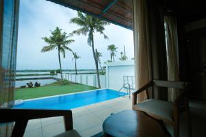 a room with a view of a swimming pool at 36 Palms- Sun and Sand in Cochin