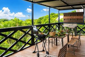 a view from the deck of a house with a camera at 美ら海水族館まで車4分の一棟貸ヴィラちゅらジャングルリゾート in Motobu
