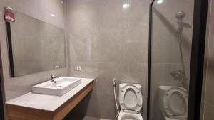 a bathroom with a sink and a toilet at AL-Yasmin in Surabaya