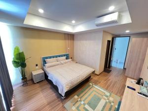 a bedroom with a large bed in a room at AL-Yasmin in Surabaya