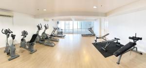 a gym with several treadmills and exercise bikes at Female Hostel wakakapacker in Kuala Lumpur