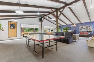 a living room with a ping pong table in it at Manowhenua Lodge Hostel in National Park