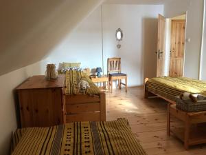 a bedroom with two beds and a table and a chair at Villa Tourmaline in Kremnica