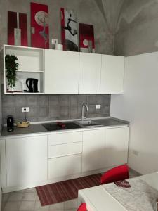 a kitchen with white cabinets and a sink at Mana House2 in Maiori +30 photos