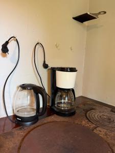 a coffee maker and a glass container on a counter at Lejnieki Apartment 2 in Pape