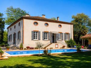 a house with a swimming pool in front of it at Manoir de La Gravette Authentic French Manor Experience in Montauban