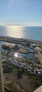 an aerial view of a parking lot next to the ocean at VELOR Hotel apartment in Batumi