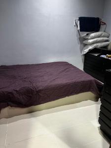 a bedroom with a bed and a dresser at Inap Seri homestay in Jeram