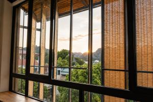 an open window with a view of the mountains at The Laneway Hostel in Xuân Sơn +32 photos