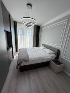 a bedroom with a bed and a large window at Best Luxury Residence in Bistriţa