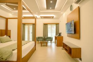 a hotel room with a bed and a desk at 36 Palms- Sun and Sand in Cochin