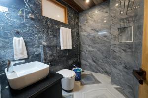 a bathroom with a sink and a shower at LN Grand Premium & Luxury Suites, Manali in Manāli +33 photos