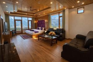 a living room with a couch and a table at LN Grand Premium & Luxury Suites, Manali in Manāli