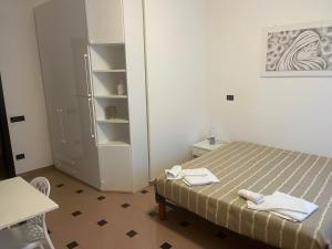 a small bedroom with a bed and a refrigerator at Casa 2019 in Matera +10 photos