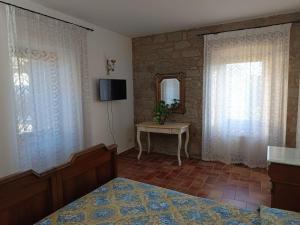 a bedroom with a bed and a mirror and a table at B&B La Camilla in Sipicciano