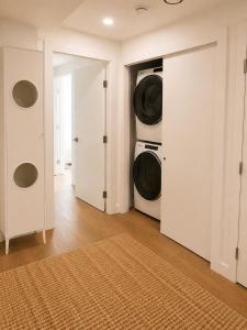 a laundry room with a washer and dryer in it at Okanagan Valley Beautiful 2 beds 2 bath in Vernon +1 photo