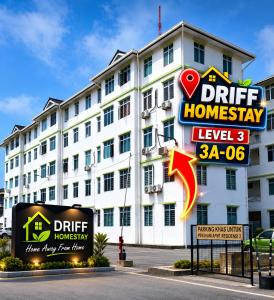 a white building with a sign in front of it at DRIFF Homestay 3bedroom with aircond 50m to Night Market Wakaf Che Yeh in Kota Bharu