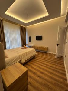 a hotel room with two beds and a tv at Villa suit in Trabzon