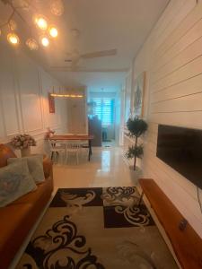 a living room with a couch and a table at DRIFF Homestay 3bedroom with aircond 50m to Night Market Wakaf Che Yeh in Kota Bharu