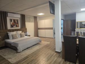 a bedroom with a bed and a desk and a television at Studio Aurora Blue in Eforie Sud