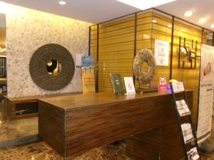 a store with a wooden counter in a room at Alasra Suites in Ulot