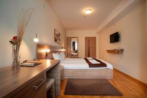 a hotel room with a bed and a desk at Park Lakeside Ohrid in Ohrid +120 photos