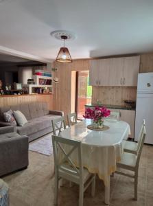 a kitchen and living room with a table with flowers on it at Buknari in Buknari +87 photos