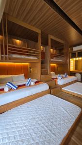 a group of four beds in a room at Palmelía Beach Resort in Buruanga +92 photos
