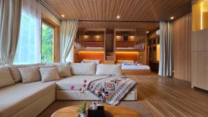 a living room with a white couch in a room at Palmelía Beach Resort in Buruanga