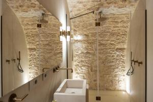 a bathroom with a sink and a glass shower at Tenuta Legaro in Cozzana +42 photos