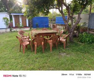 a group of chairs around a table in a yard at New Guest in Nilaveli