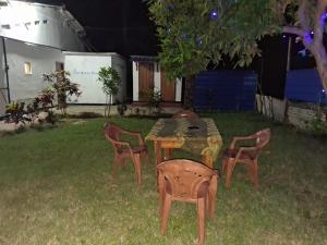 a table and chairs in a yard at night at New Guest in Nilaveli +23 photos